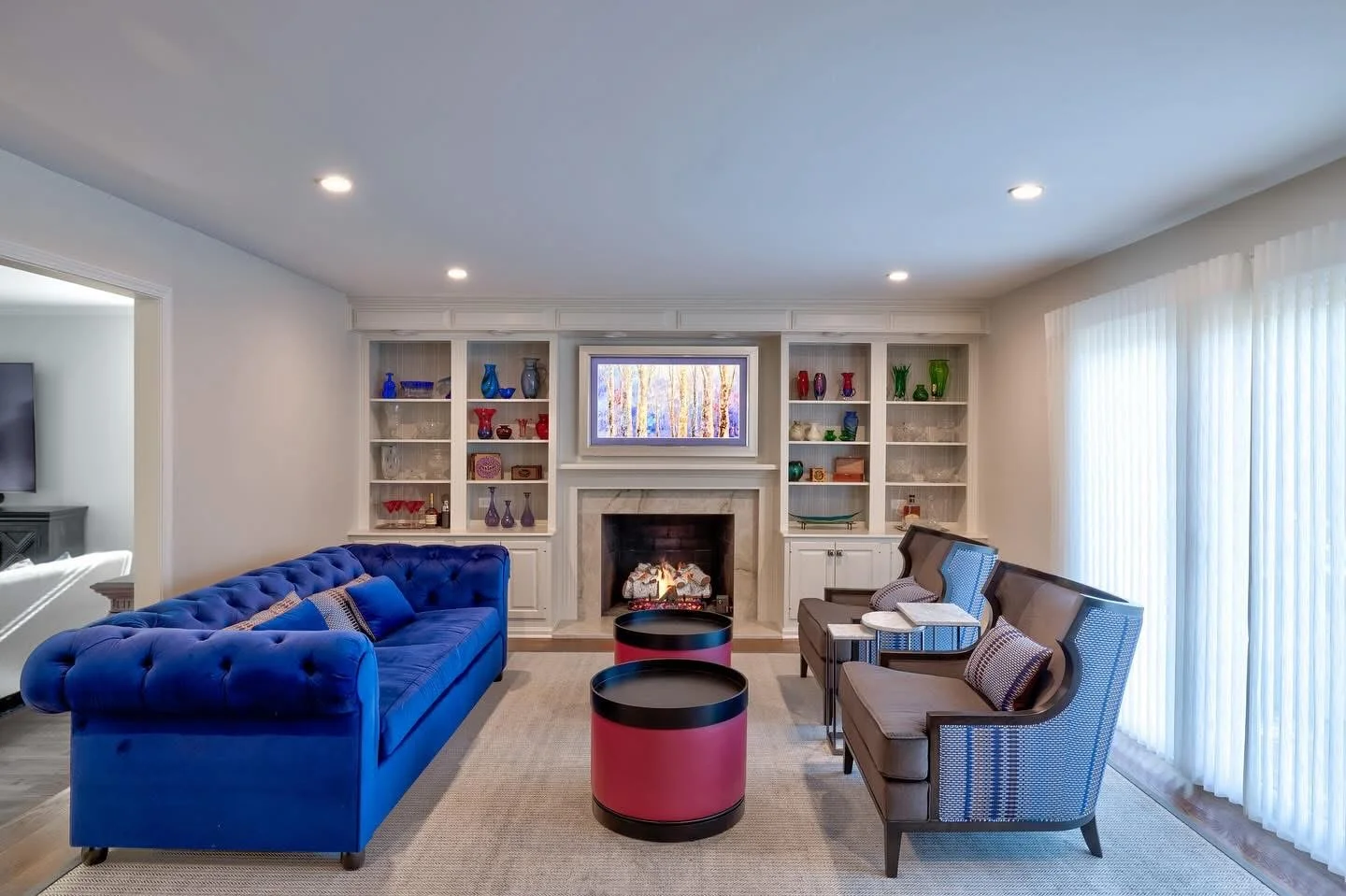 Custom white built-in shelving with fireplace, blue sofa, and decorative accessories