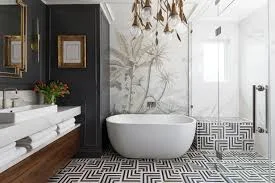 Modern bathroom with freestanding tub, marble accent wall, and geometric floor tile