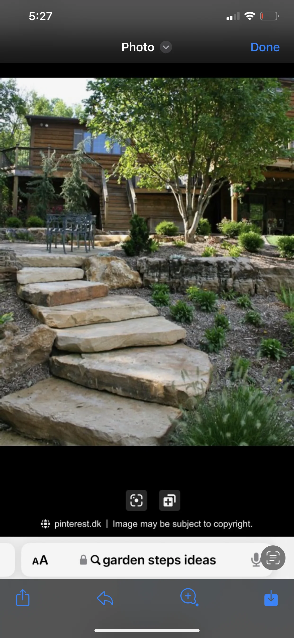 Natural stone steps and retaining wall with landscaping in residential yard