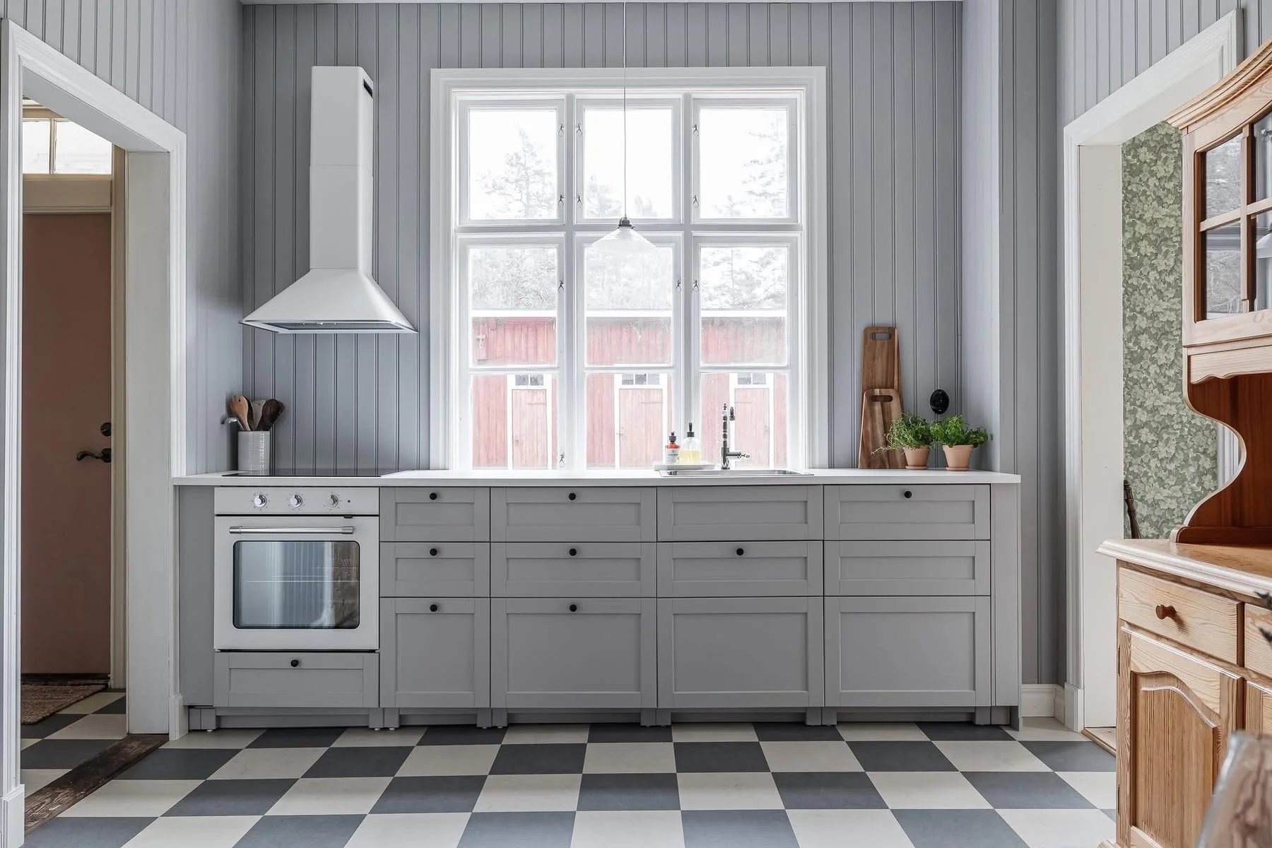 Modern farmhouse kitchen with gray cabinetry, stainless steel appliances, and geometric tile flooring