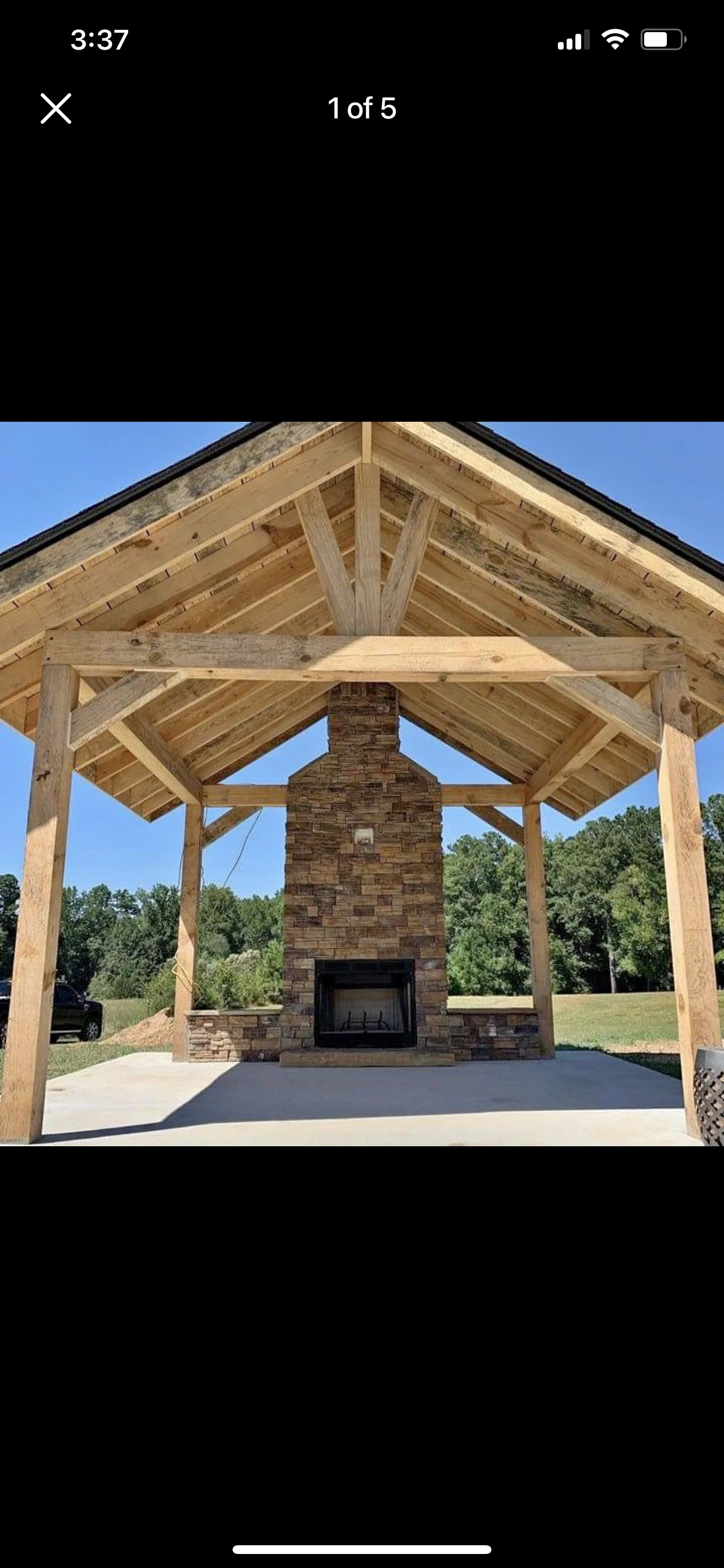 Timber frame pavilion with brick fireplace and exposed beam construction