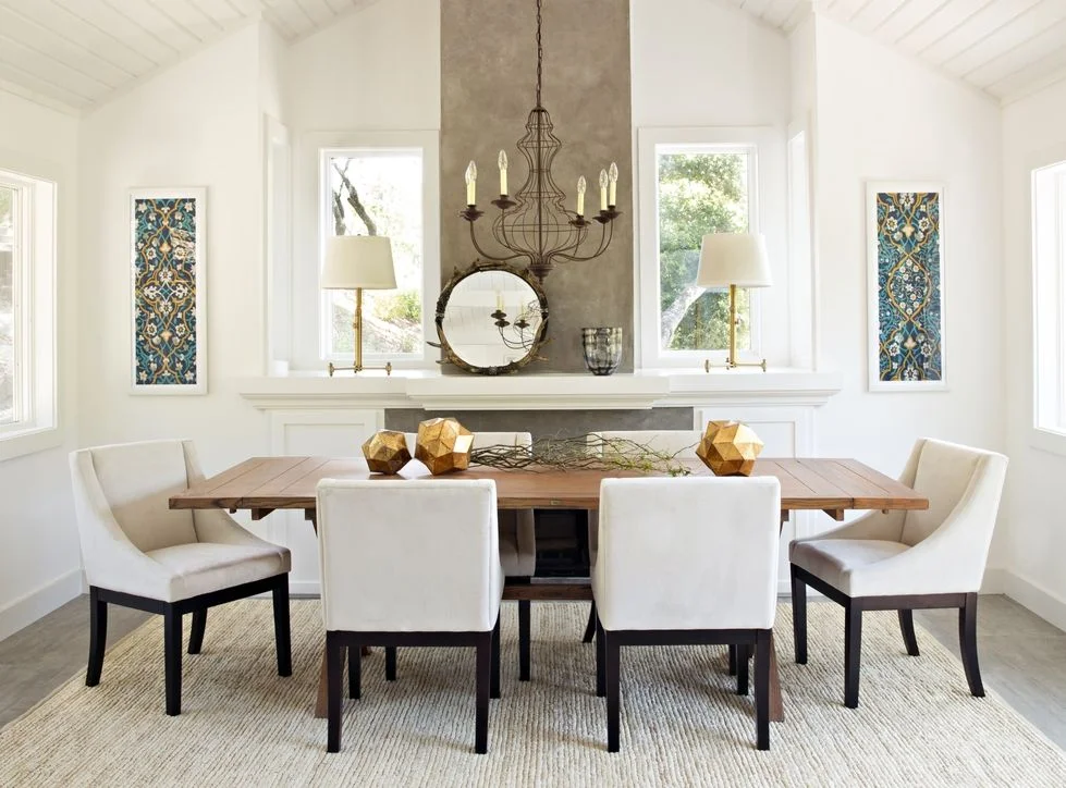 Modern dining room with fireplace feature wall, wood table, and cream upholstered chairs