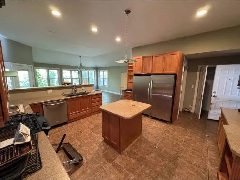 Modern kitchen with cherry cabinets, stainless steel appliances, and center island