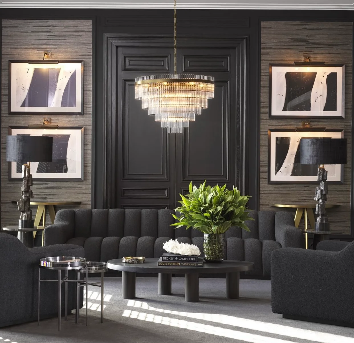Modern entryway with dark millwork, tiered chandelier, and charcoal sofa