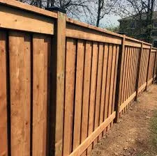 Custom cedar wood fence with vertical boards and horizontal beams in Barrington