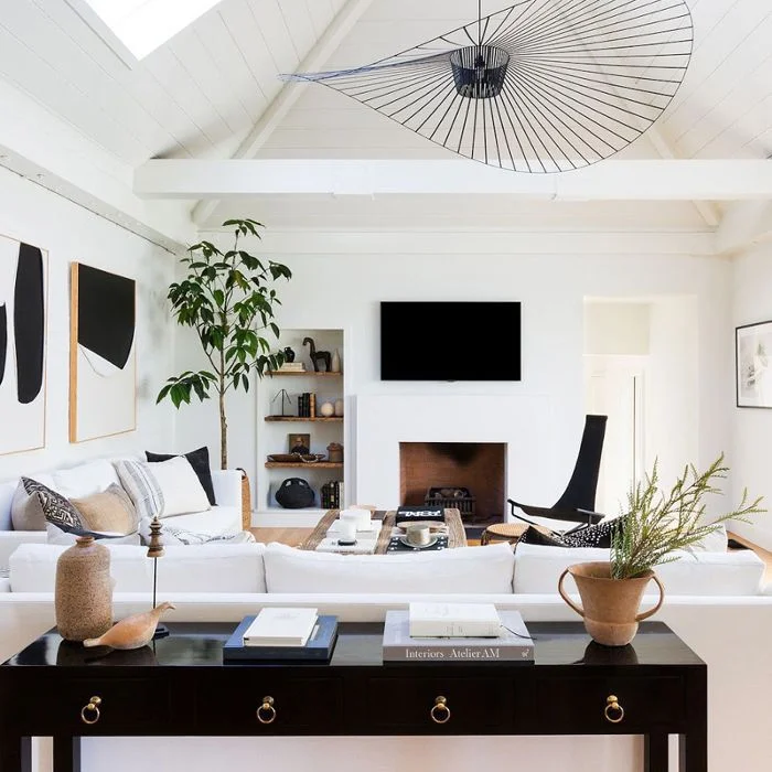 Modern living room with fireplace, vaulted ceiling, and contemporary furnishings