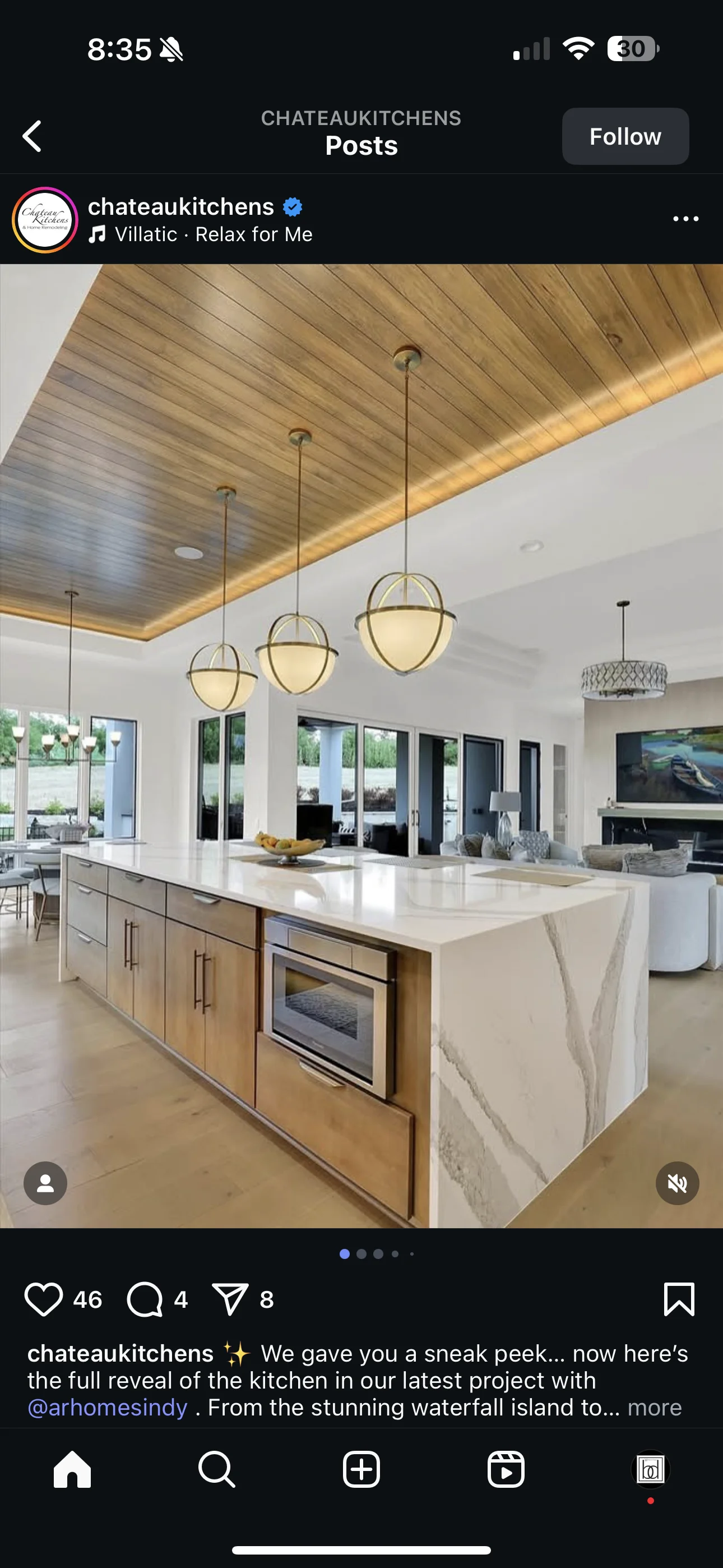 Modern kitchen with waterfall island, wood ceiling, and pendant lighting